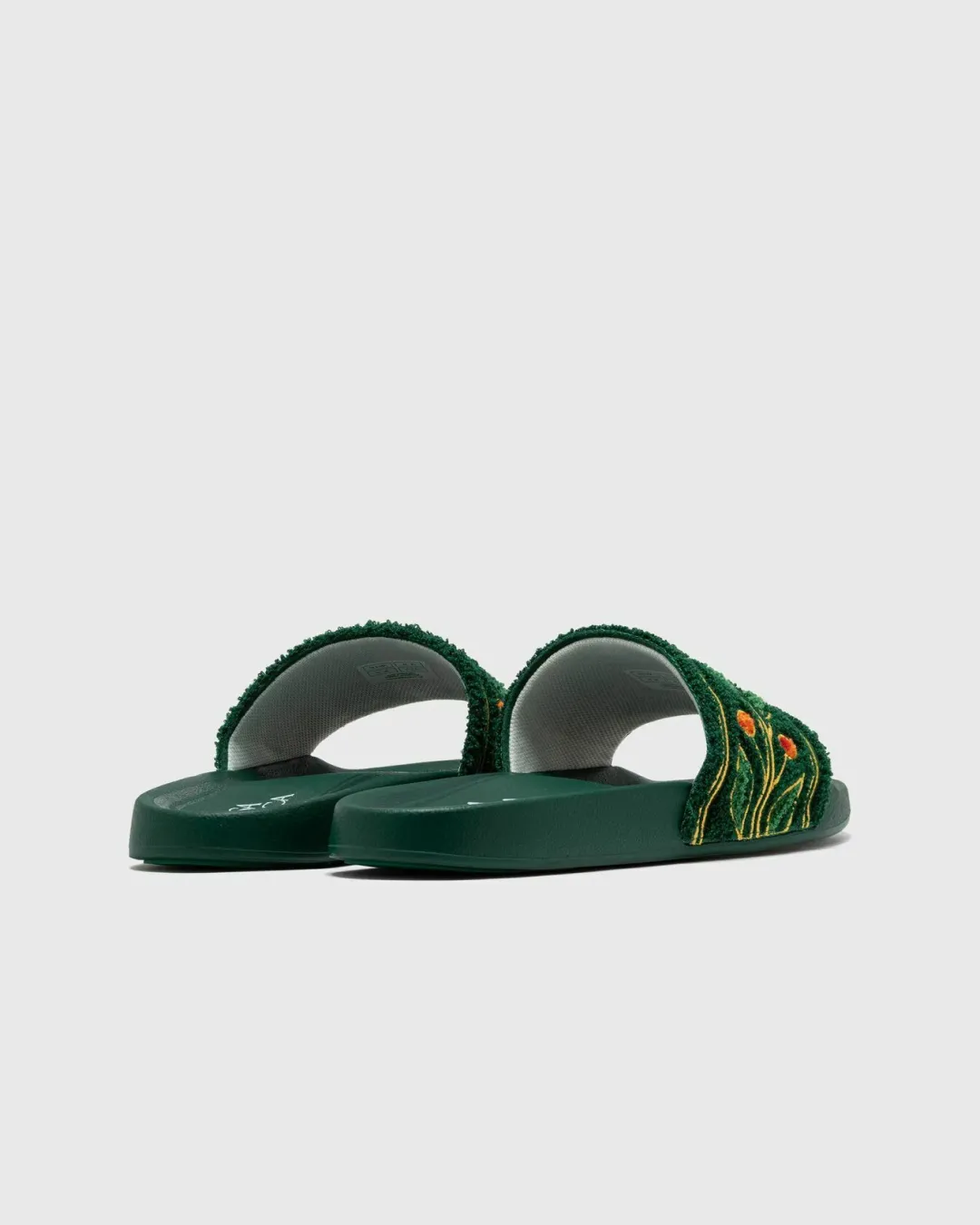 Casablanca Embroidered Terry Slider in Green running during a full moon