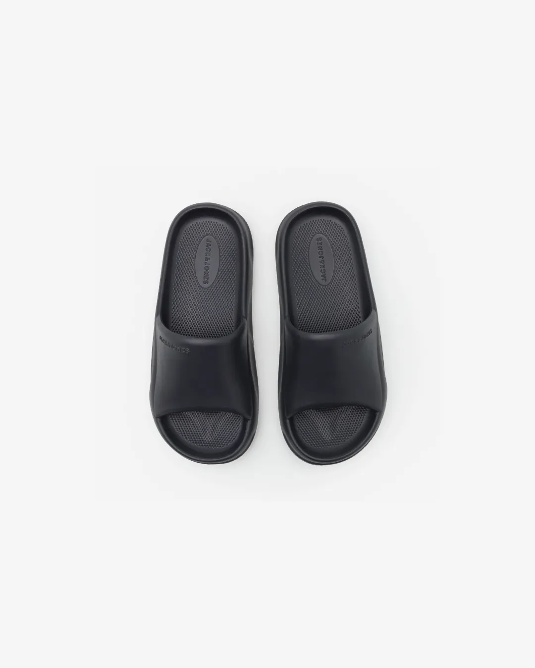 Jack & Jones Slider in Black running in a gondola station area shoes